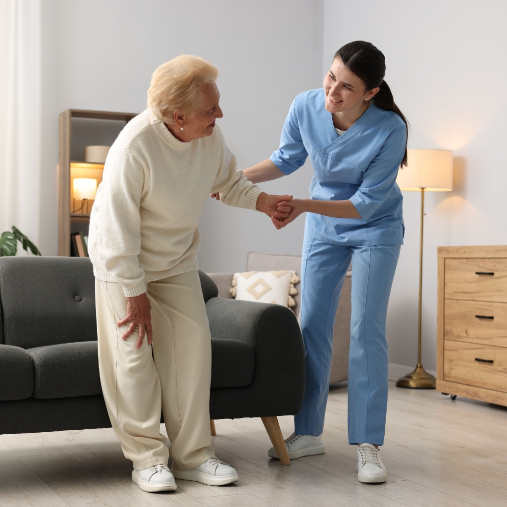 A caregiver helping a resident with personal care at Heart House